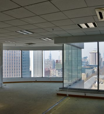 Empty, big open-space office room with panoramic view at modern city in China. During remodeling improvement work.