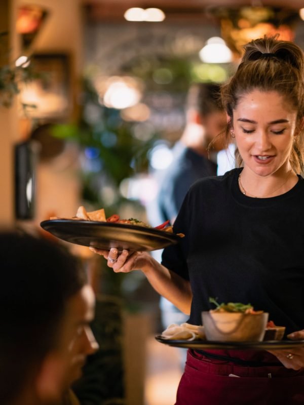 A waitress serving customers food at a restaurant in Newcastle-Upon-Tyne.