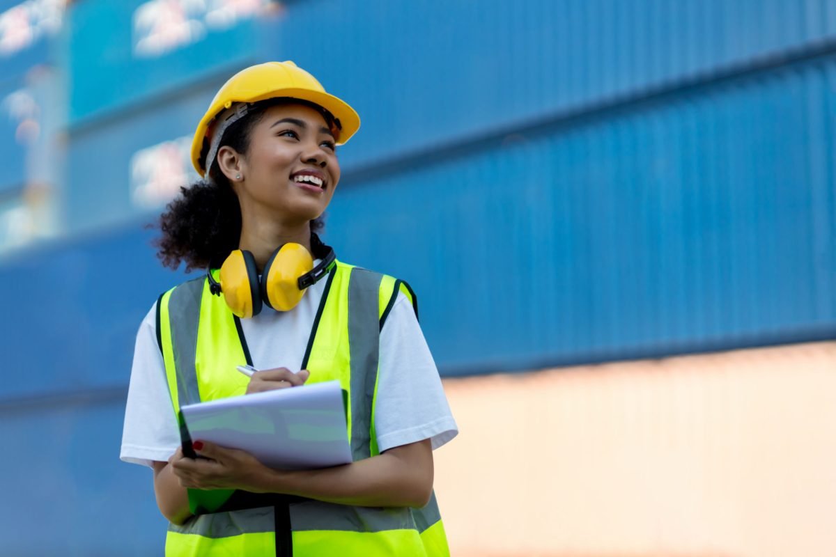 Foreman or worker hand holding checklist for writing and checking in goods in container at Container cargo site.